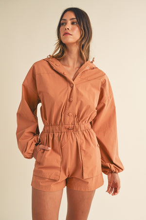 In a Snap Button Hooded Romper in Tan