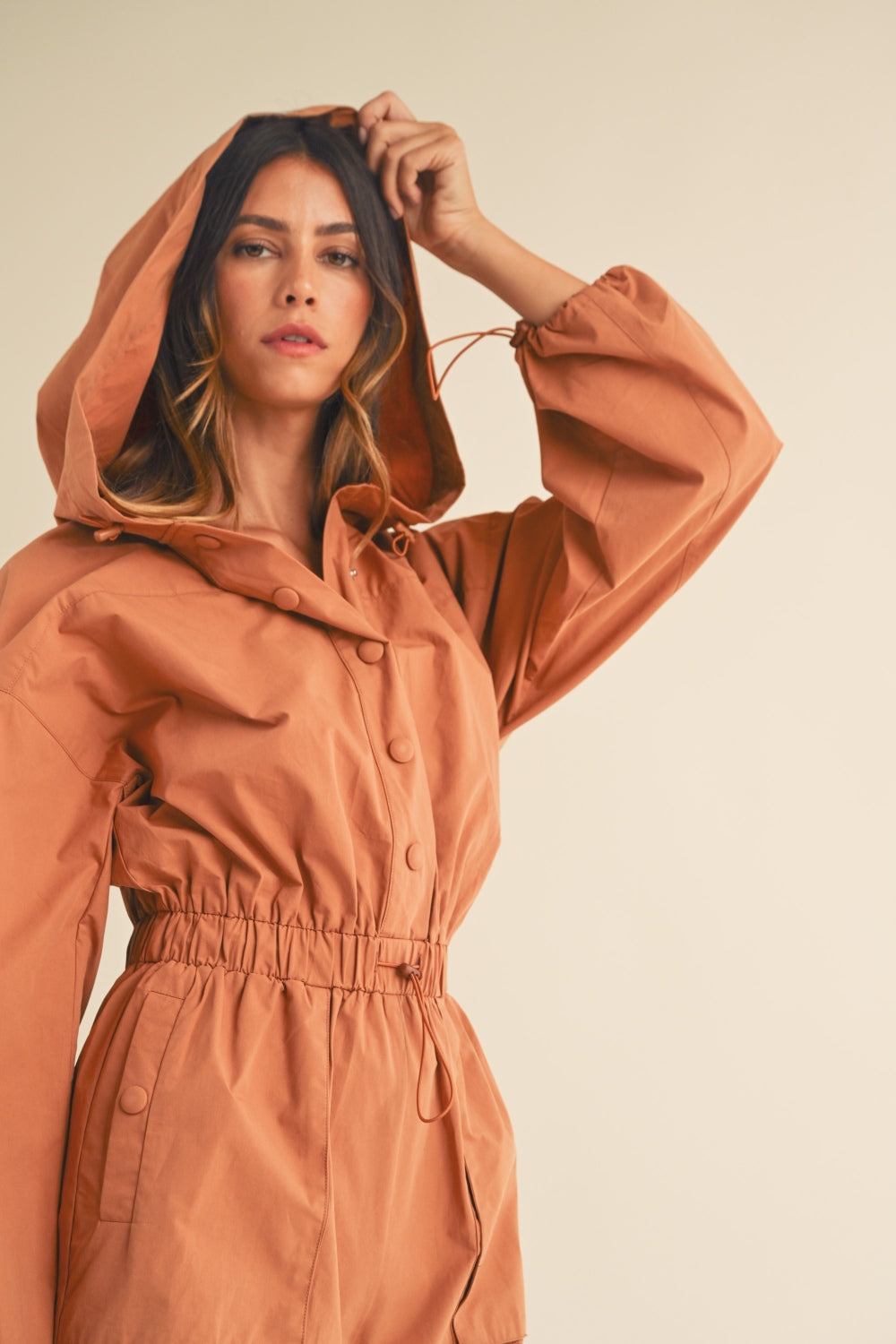 In a Snap Button Hooded Romper in Tan