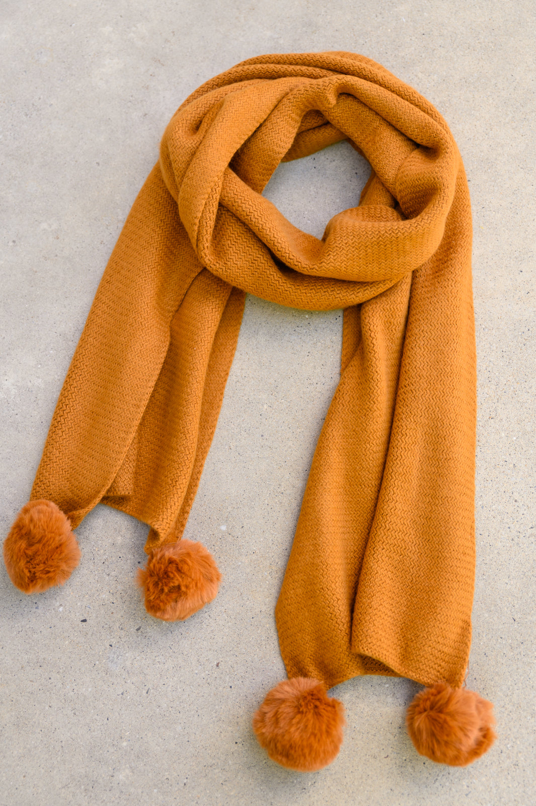 What's the Fuzz Knitted Pom Pom Scarf In Ginger